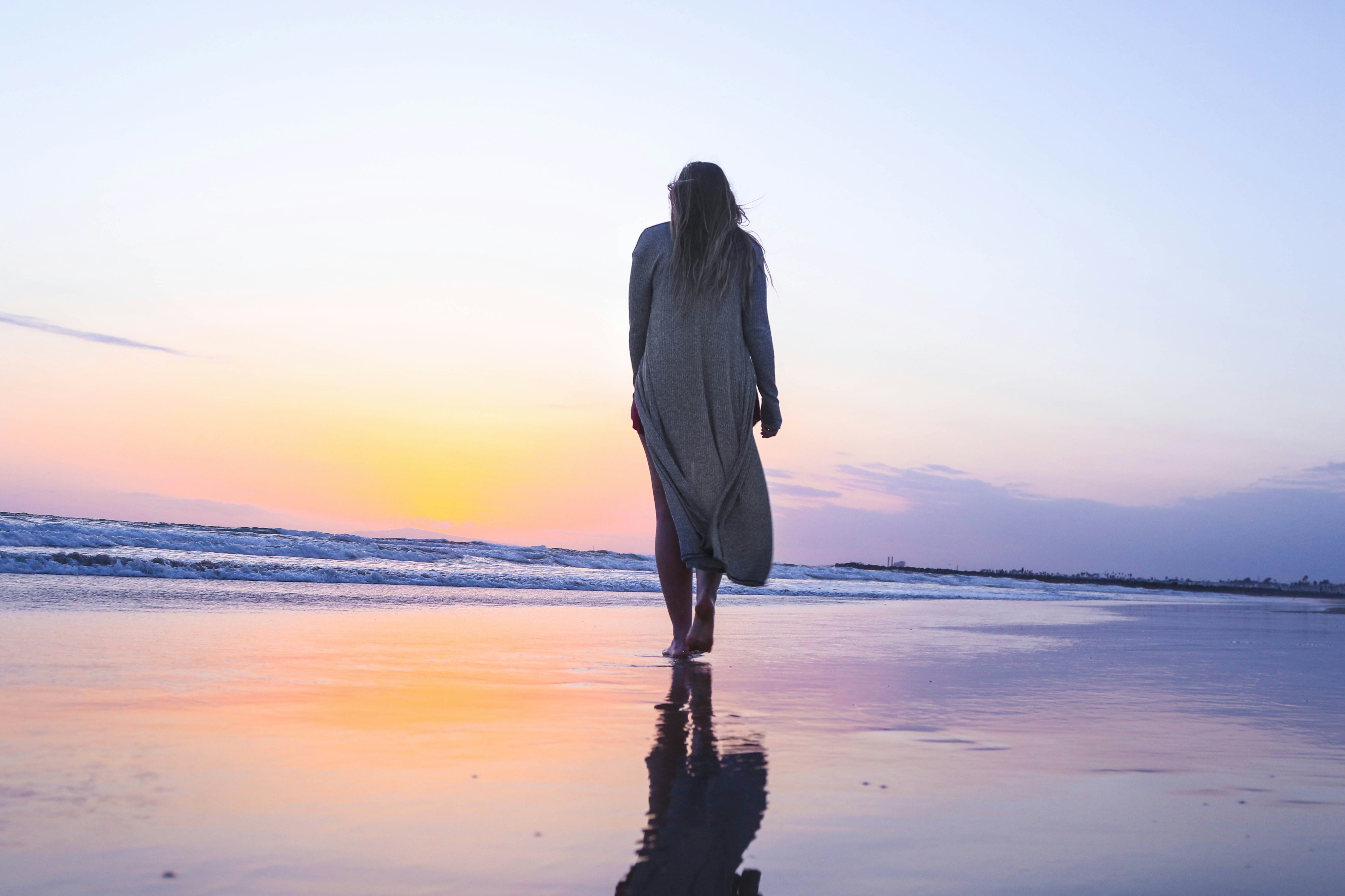 Woman walking alone toward the horizon with courage